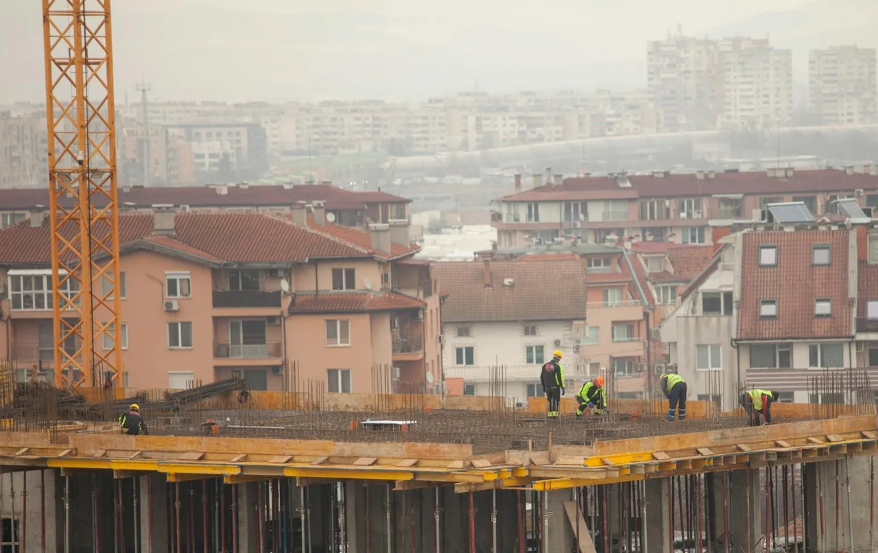 Active construction site with workers in hard hats and heavy equipment in Canada