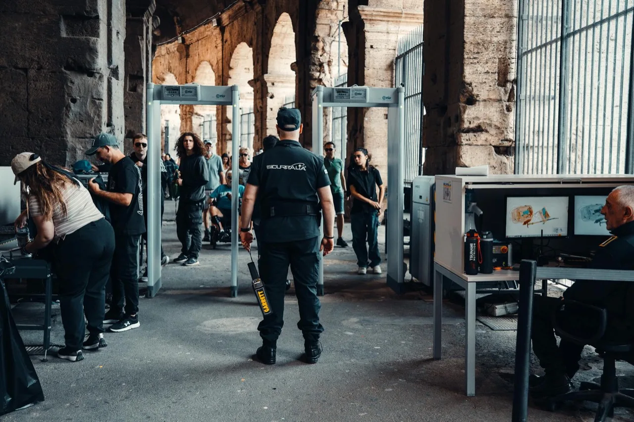 Security checkpoint with walk-through metal detector screening visitors at Canadian venue entrance