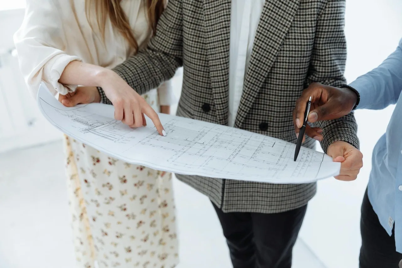 Security consulting team reviewing floor plans for Canadian event risk assessment