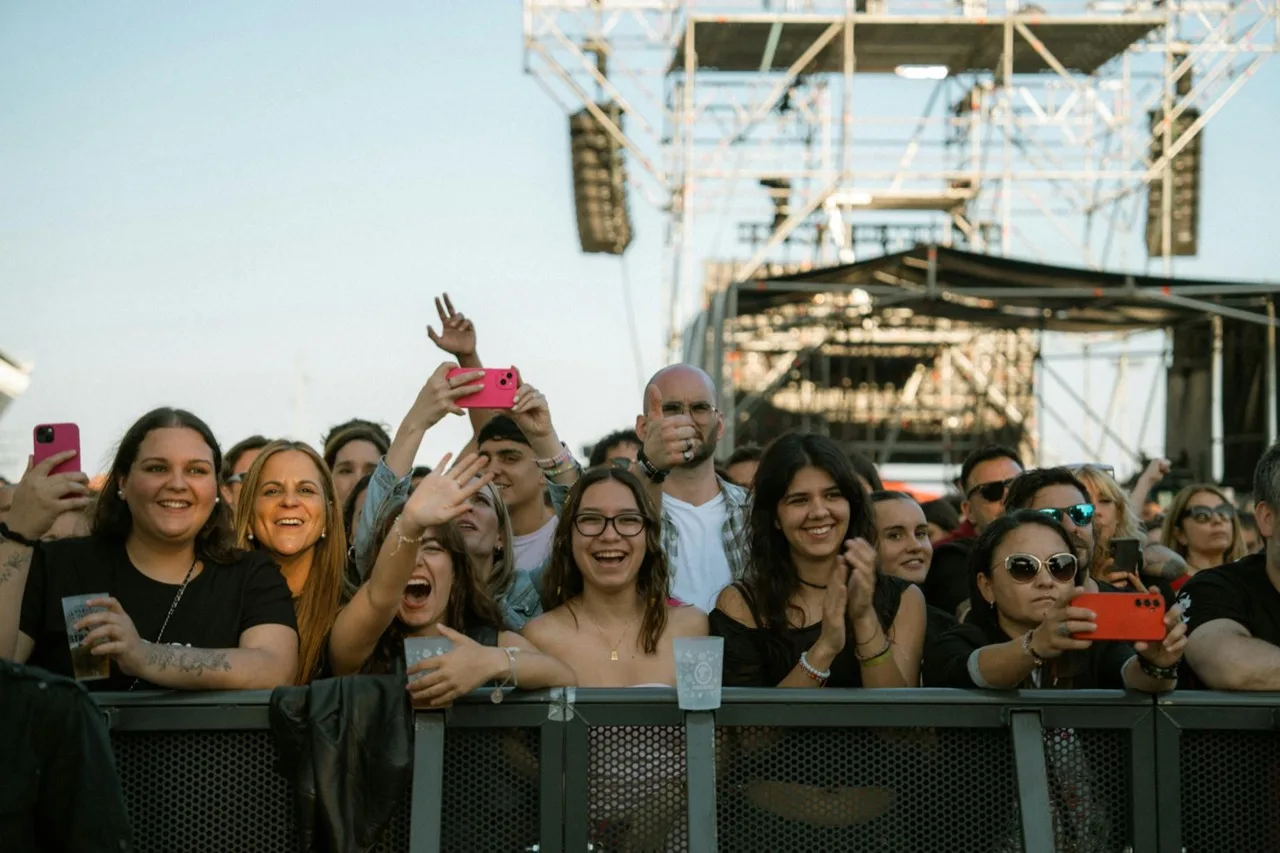 Steel crowd control barricades with fans behind metal barriers at outdoor Canadian concert